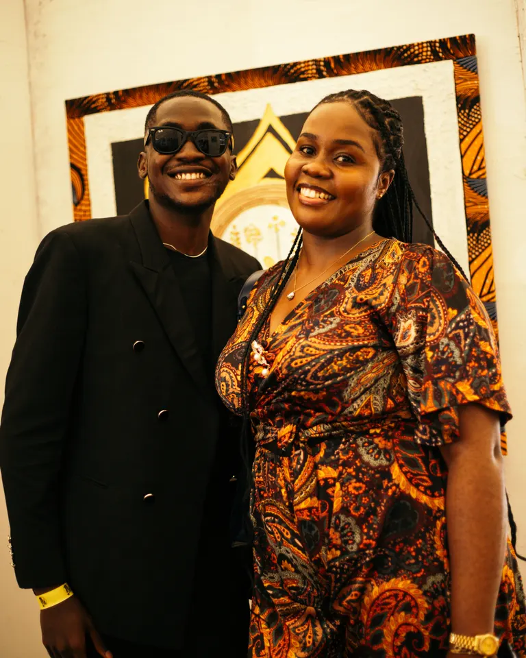 Two smiling guests in the gallery at the KAFART Pop-Up in Abuja.